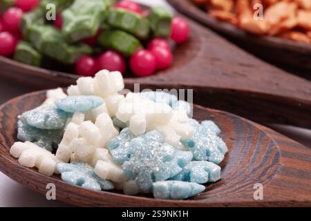 Wooden spoons with christmas cake sprinkles on isolated on a white background. Stock Photo