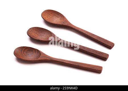 Three dark wooden spoons islolated on a white background Stock Photo