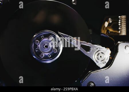 Hard drive with its read-write head poised over the platter, demonstrating mechanical precision Stock Photo