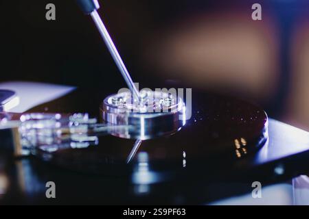 A close-up of a screwdriver on a disassembled hard drive Stock Photo