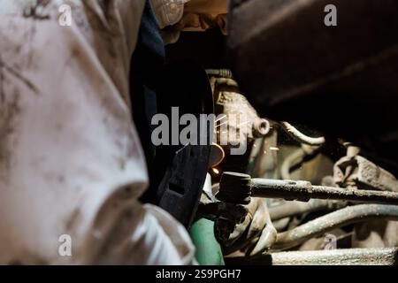 Sparks Fly as a Mechanic Performs Precision Welding on Automotive Components. Stock Photo