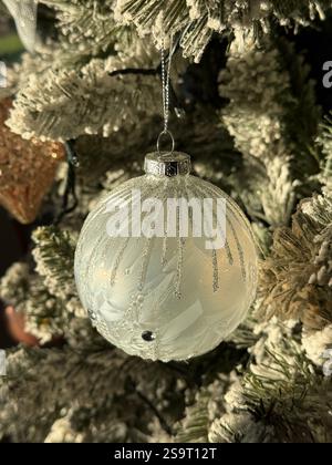 Christmas tree decoration in the form of a modern style white pearly ball with silver ornamentation Stock Photo
