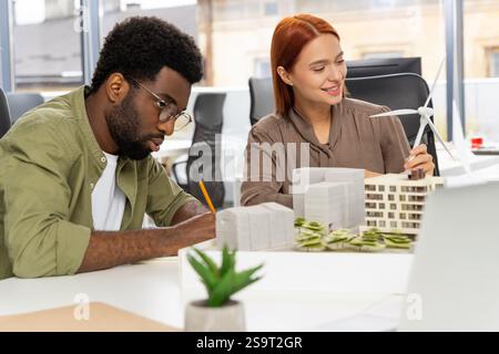 Colleagues working in the office and developing a new sustainable project Stock Photo