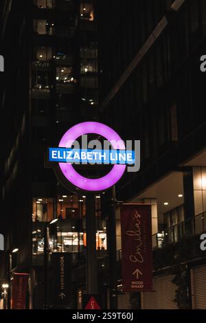 London Elizabeth Line Roundel at night Stock Photo - Alamy