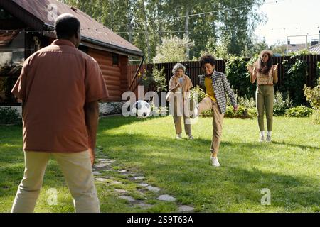 Playing Soccer in Backyard with Family Members Stock Photo