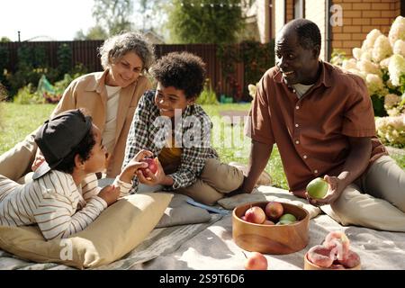Enjoying A Sunny Picnic Day with Fresh Fruit Stock Photo
