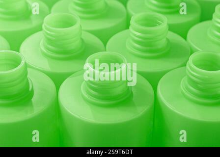 Lots of empty green plastic bottles, production or recycling line. Close up shot, abstract industrial background. Stock Photo