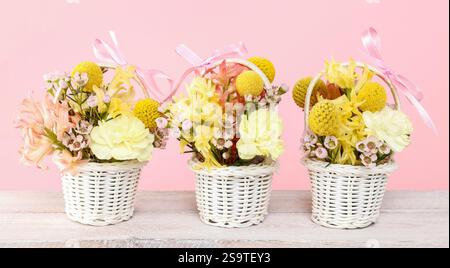 Three tiny baskets with flowers. Party decor Stock Photo