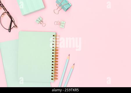 Mint colored school supplies on a pink background. Place for your design. Stock Photo