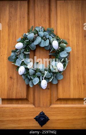 Elegant Easter Wreath on Wooden Door Stock Photo