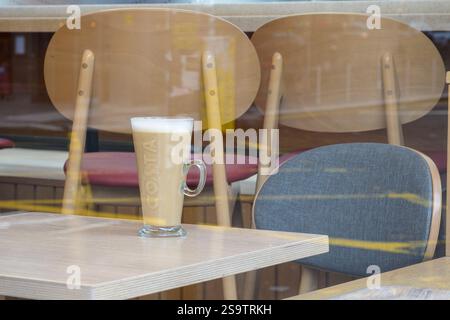 Looking in through a Costa cafe to a coffee cup on a table, Glasgow, Scotland, UK, Europe Stock Photo