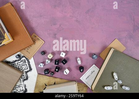Tabletop role playing flat lay with black and white RPG dices, rule books, dungeon map on purple background with copy space Stock Photo