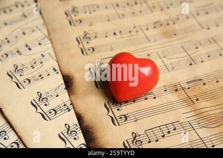 Heart figure on musical note sheets, closeup Stock Photo