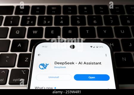 DeepSeek AI app in android app store with the option to open and delete the app. The smartphone placed on laptop keyboard. Concept. Stafford, United K Stock Photo