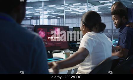 Woman requesting help from cybersecurity team after seeing security incidents affecting data center network system, protecting infrastructure from hacker attacks, camera A Stock Photo