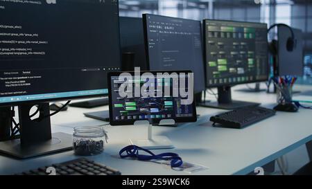 Close up of headphones left by worker on server room PCs used by employees working to ensure minimal downtime. Equipment in data center workplace used for monitoring performance Stock Photo