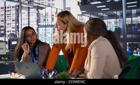 Diverse general managers collaborate in office analyzing data for expansion plan, corporate feminism. Female CEOs discussing strategies for leadership development, achieve greatness. Camera B. Stock Photo