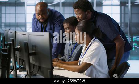 Coworkers in data center doing brainstorming, implementing AI predictive maintenance systems. Server hub colleagues discussing, using artificial intelligence to identify hardware failures, camera A Stock Photo