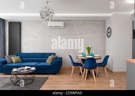 Modern Apartment with Blue Sofa and Dining Area Stock Photo