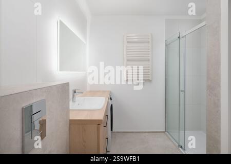 Bright Modern Bathroom with Shower and Lighted Mirror Stock Photo