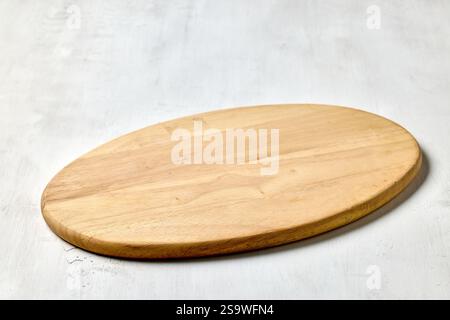 empty clean wooden cutting board on white kitchen table background Stock Photo