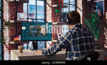 Man listening music while using AI program turning text prompt into videos. Person putting on headphones, interacting with text to video artificial intelligence generative model, camera A Stock Photo