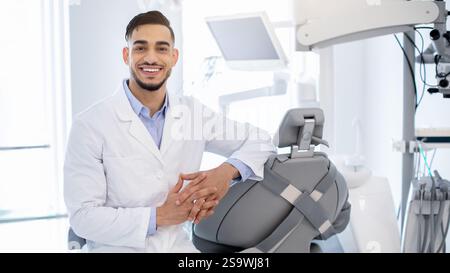 Dental Services. Portrait Of Professional Arab Stomatologist Doctor Posing At Workplace Stock Photo