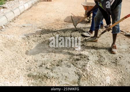 Men using tools to mix marter on construction site. Stock Photo