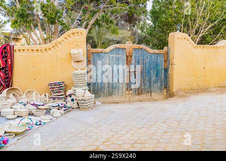 Faiyum, Egypt. Blue painted wooden gate in a wall. Stock Photo