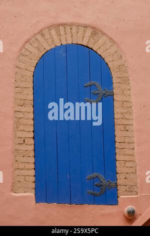 Marrakech, Morocco. Blue gate situated on old wall. Stock Photo