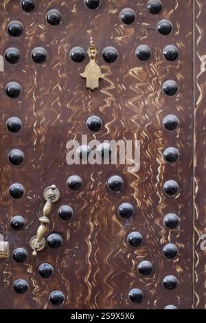 Marrakech, Morocco. Old brown door with metal hardware Stock Photo