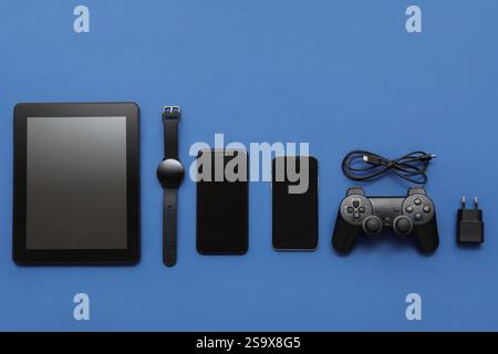 Composition with different modern gadgets on blue background Stock Photo