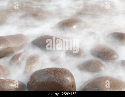 Ireland, Kinard. Close-up of wave on smooth beach rocks. Stock Photo