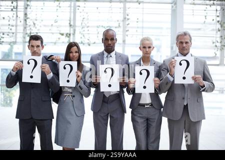 Portrait, business and people with question marks in office for confusion, management doubt and solution. Staff, unsure and diversity for problem Stock Photo