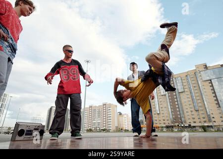 Performing Breakdancing Moves in Urban Environment Stock Photo