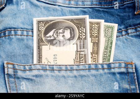 Old Philippine money - peso in the pocket of blue jeans Stock Photo