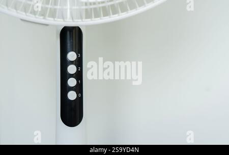 Cropped image of white modern electric fan in room and selective focus on the number. Space for text Stock Photo
