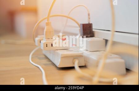Cropped shot of the power plug, Multiple socket with connected plugs. Selective focus, close up. Stock Photo