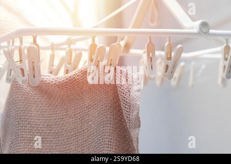 Shot of kitchen towel hanged on the clamping rack. Laundry or house works concept. Selective focus. Stock Photo