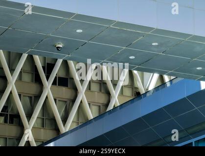 Close-up detail shot showcasing the architectural intricacies of a modern Hong Kong building.  The image emphasizes intersecting lines and contrasting Stock Photo