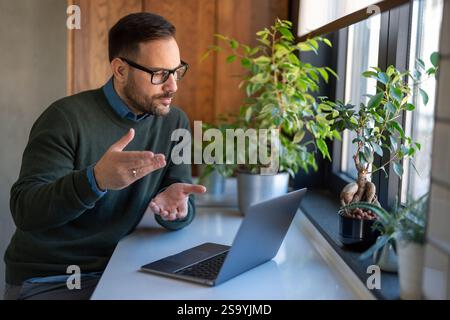 Success man typing on laptop, communicating online distantly working or studying on computer at home Stock Photo