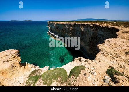 Coastline with colourful steep rock cliffs on the coast around S' Arena Scoada. Stock Photo