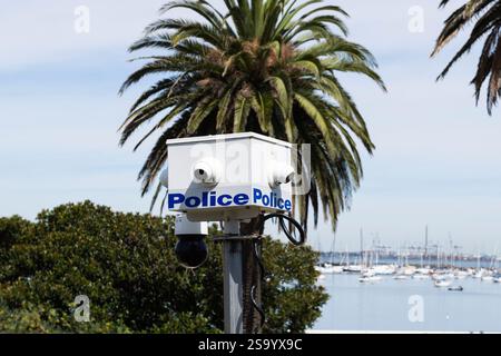 Australian police monitoring with a solar powered surveillance camera on a telescopic pole to combat crime in Melbourne Australia. Crime prevention. Stock Photo