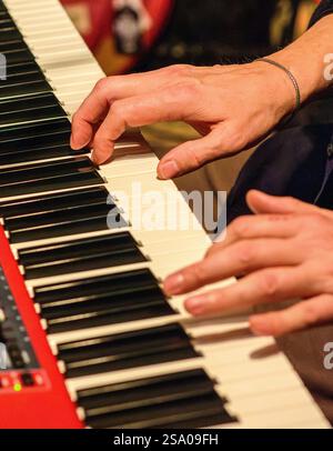 Musicians hands playing electronic piano keyboard - France. Stock Photo