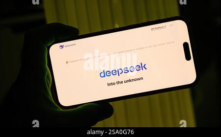 Paris, France - Jan 28, 2025: Smartphone screen displaying DeepSeek's logo and slogan Into the unknown nnouncement highlights the launch of the R1 mod Stock Photo