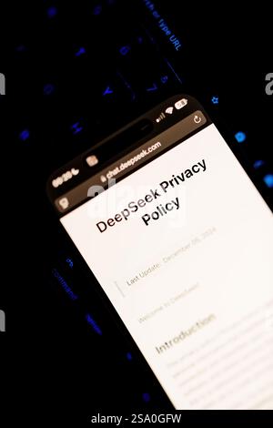 Paris, France - Jan 28, 2025: A smartphone displays the DeepSeek privacy policy page with update information, set against a dark background with a sof Stock Photo