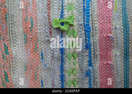 Part of the texture of a multi-colored vintage rug with a simple weave. Stock Photo