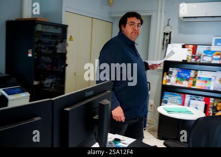 Disabled worker working in the printing, reprography and marking workshop. Stock Photo
