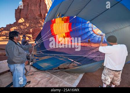 Hot air balloon getting inflated before taking off near Spearhead Mesa in Monument Valley, Arizona, USA Stock Photo