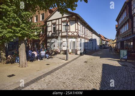 Old town, historic half-timbered houses, outdoor area of a cafe, trees, blue sky, cloudless, Brandplatz, Neue Strasse, Celle, Lueneburg Heath, distri Stock Photo